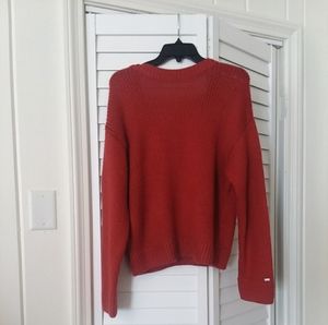 A dark orange sweater